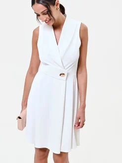 ABITO BIANCO CON REVERS E BOTTONE DESIGN
